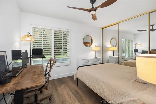 a bedroom with a bed a chair and a chandelier