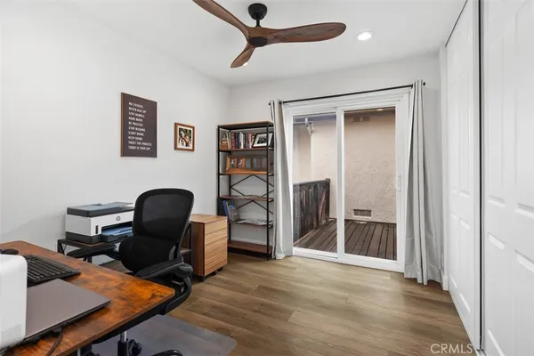 a view of a workspace with furniture and a window