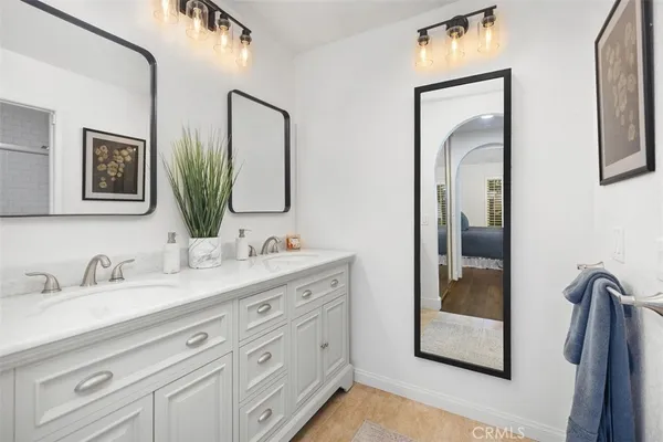 a bathroom with a double vanity sink and a mirror
