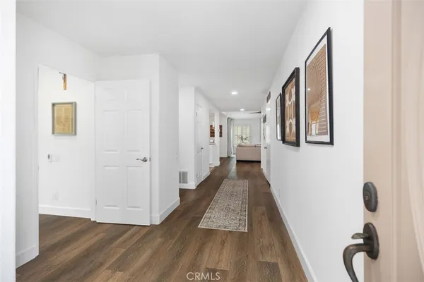 a hallway with front door wooden floor and windows