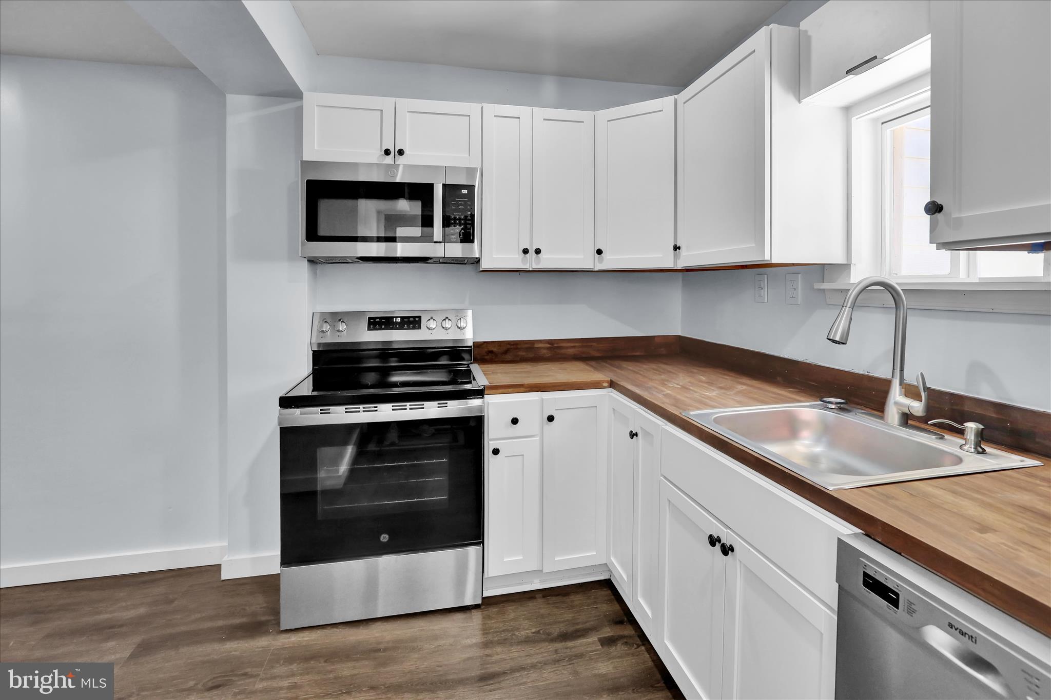 513 Manor Street Lancaster, PA 17603 - Photo 14 of 37 a kitchen with granite countertop a stove and a sink