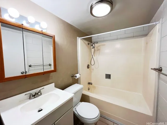 a bathroom with a sink mirror vanity and toilet