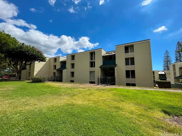 a large house with a big yard and large trees