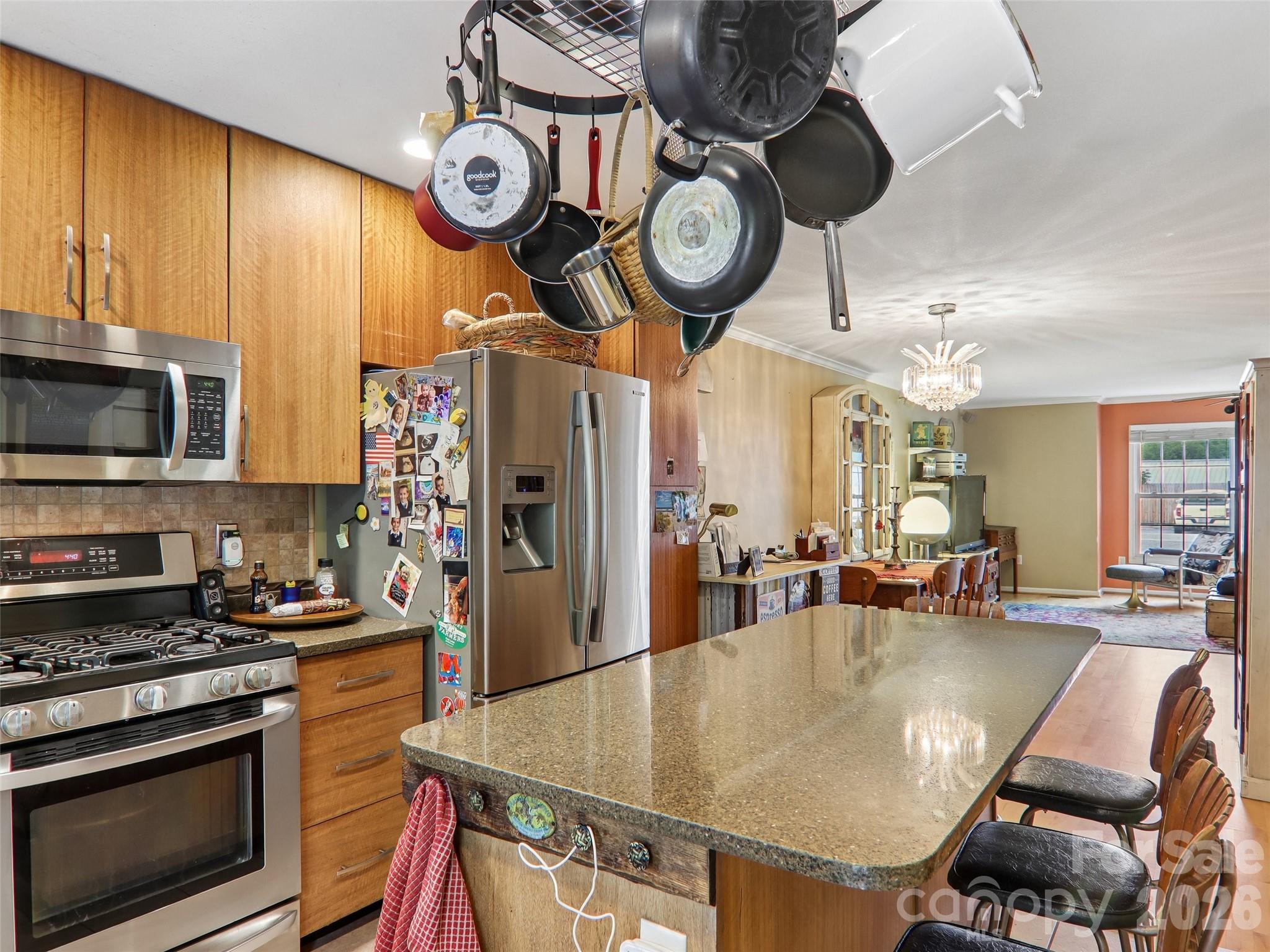 34 Union Chapel Road, Unit 7 Weaverville, NC 28787 - Photo 17 of 37 a kitchen with stainless steel appliances granite countertop a dining table and chairs
