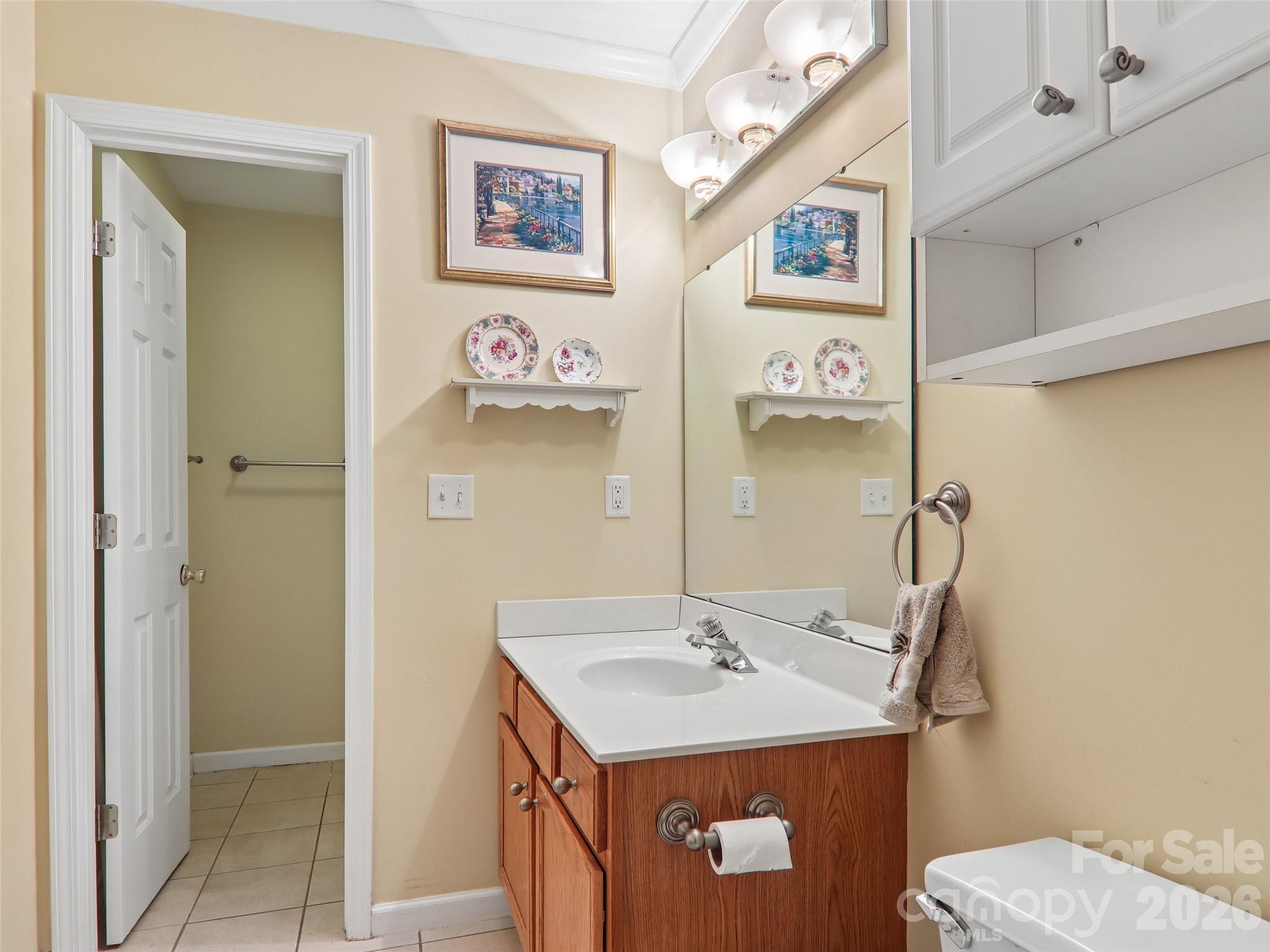 34 Union Chapel Road, Unit 7 Weaverville, NC 28787 - Photo 32 of 37 a bathroom with a sink mirror and a toilet
