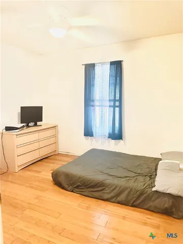 a bedroom with a bed and a night stand