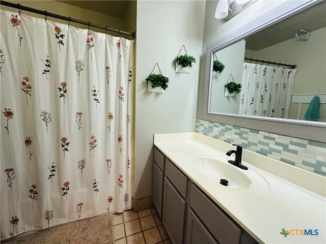 a bathroom with a sink and a mirror