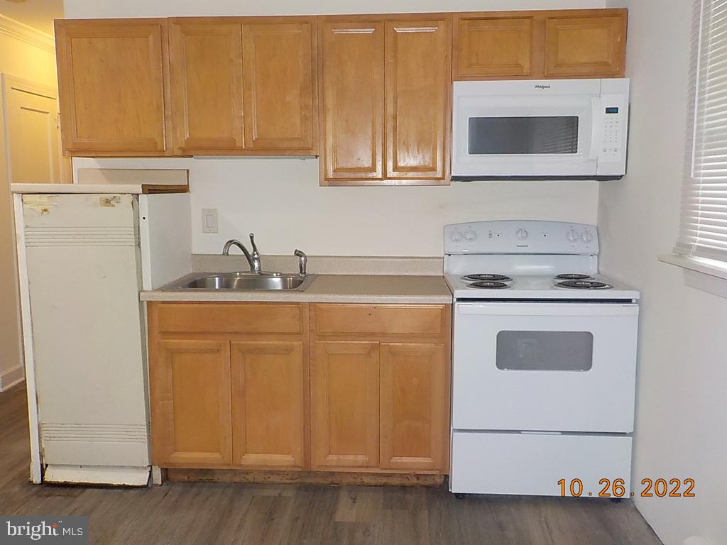 1109 Montgomery Road Wilmington, DE 19805 - Photo 3 of 11 a kitchen with white cabinets and white appliances