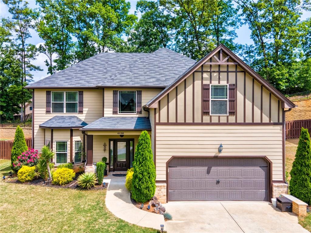 6130 Country Lake Road Cumming, GA 30041 - Photo 1 of 1 a front view of a house with a yard