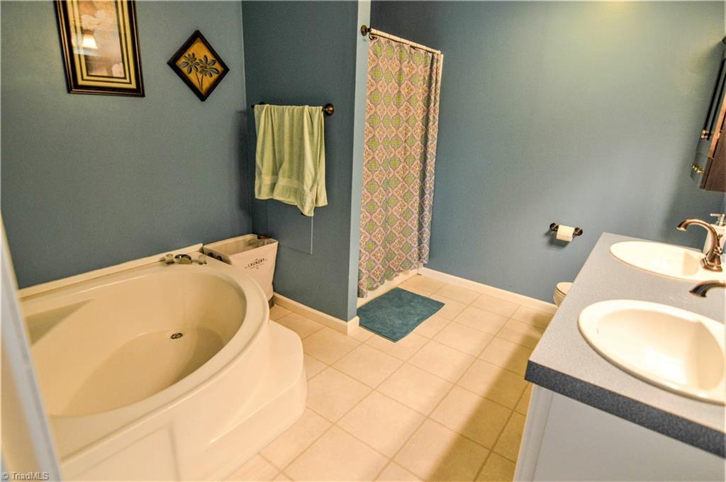 5809 Clingman Road Hamptonville, NC 27020 - Photo 16 of 22 Primary Bath with garden tub, separate shower, double vanity with plenty of room!