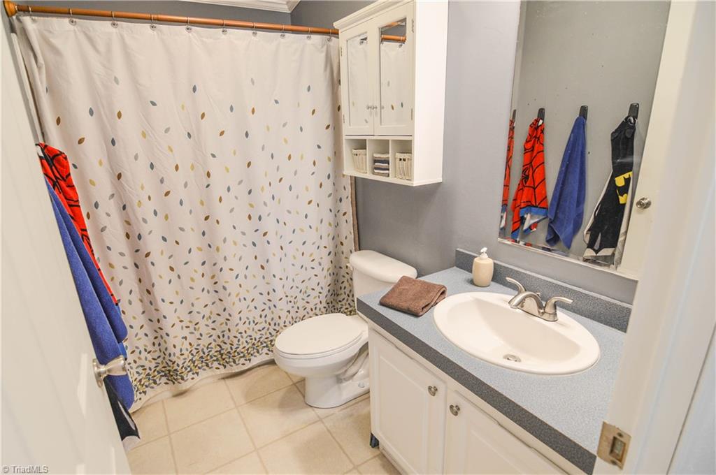 5809 Clingman Road Hamptonville, NC 27020 - Photo 20 of 22 Main bath is roomy and well maintained with fresh paint as well.