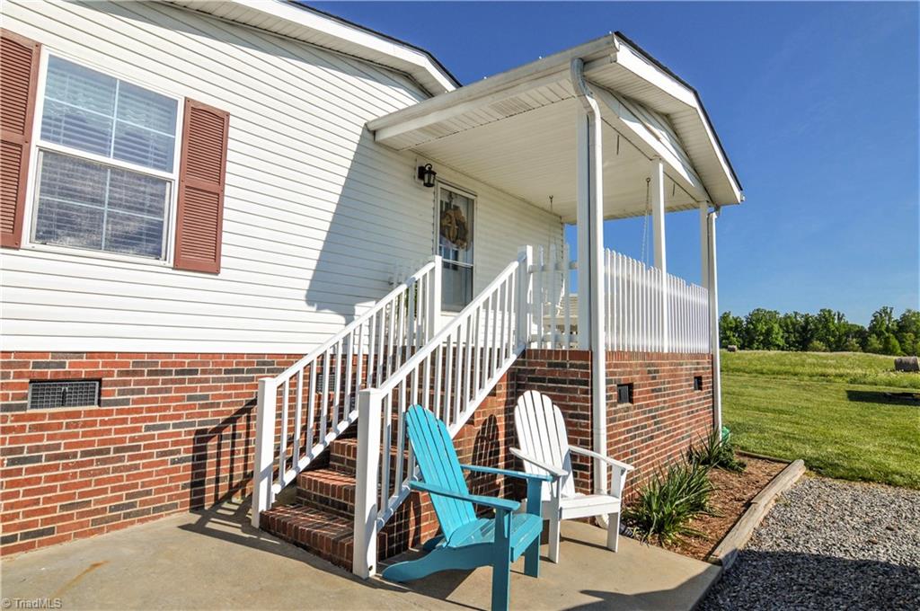 5809 Clingman Road Hamptonville, NC 27020 - Photo 4 of 22 The side porch offers great views. You can also see the large back yard as well.