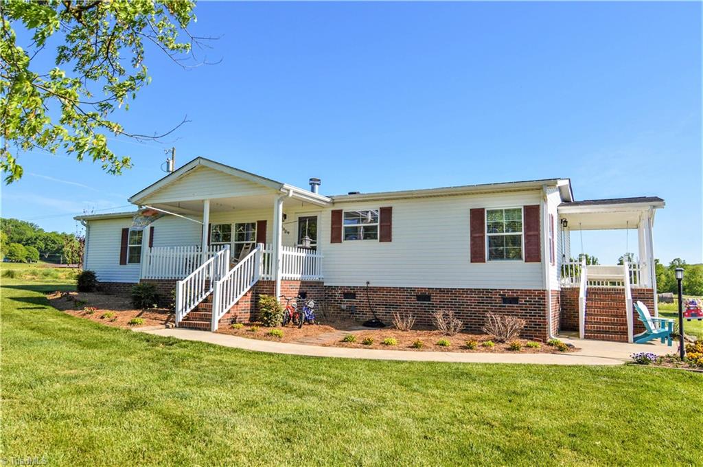 5809 Clingman Road Hamptonville, NC 27020 - Photo 6 of 22 Meticulously landscaped with walk way to each porch!