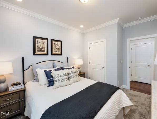 a bedroom with bed and cupboard