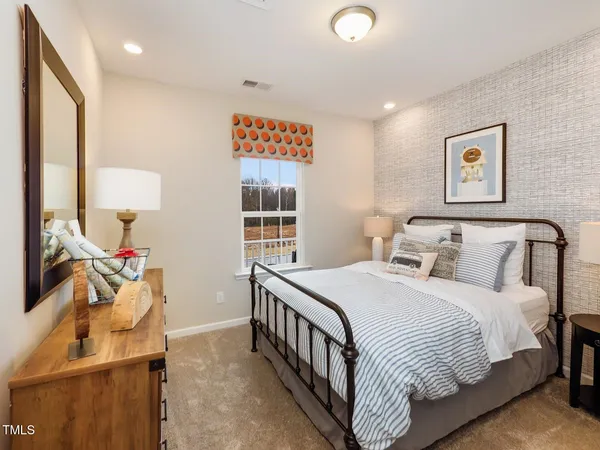 a bedroom with a bed and a dresser