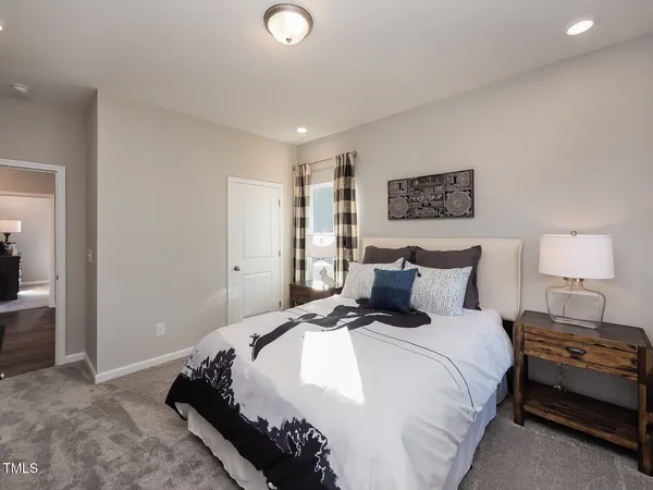 a bedroom with a bed and a night stand