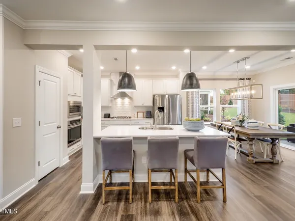 a large kitchen with a table and chairs