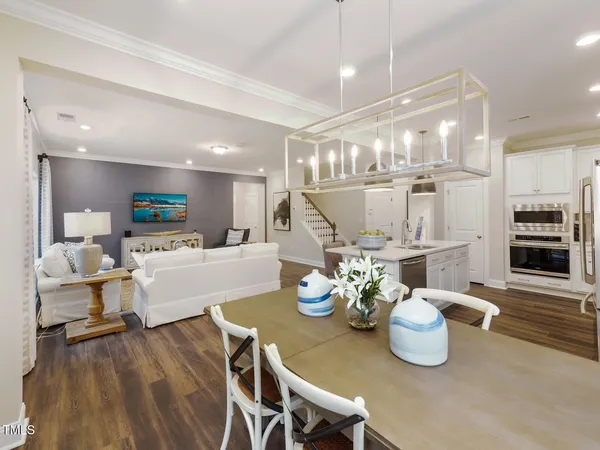 a large kitchen with a table and chairs
