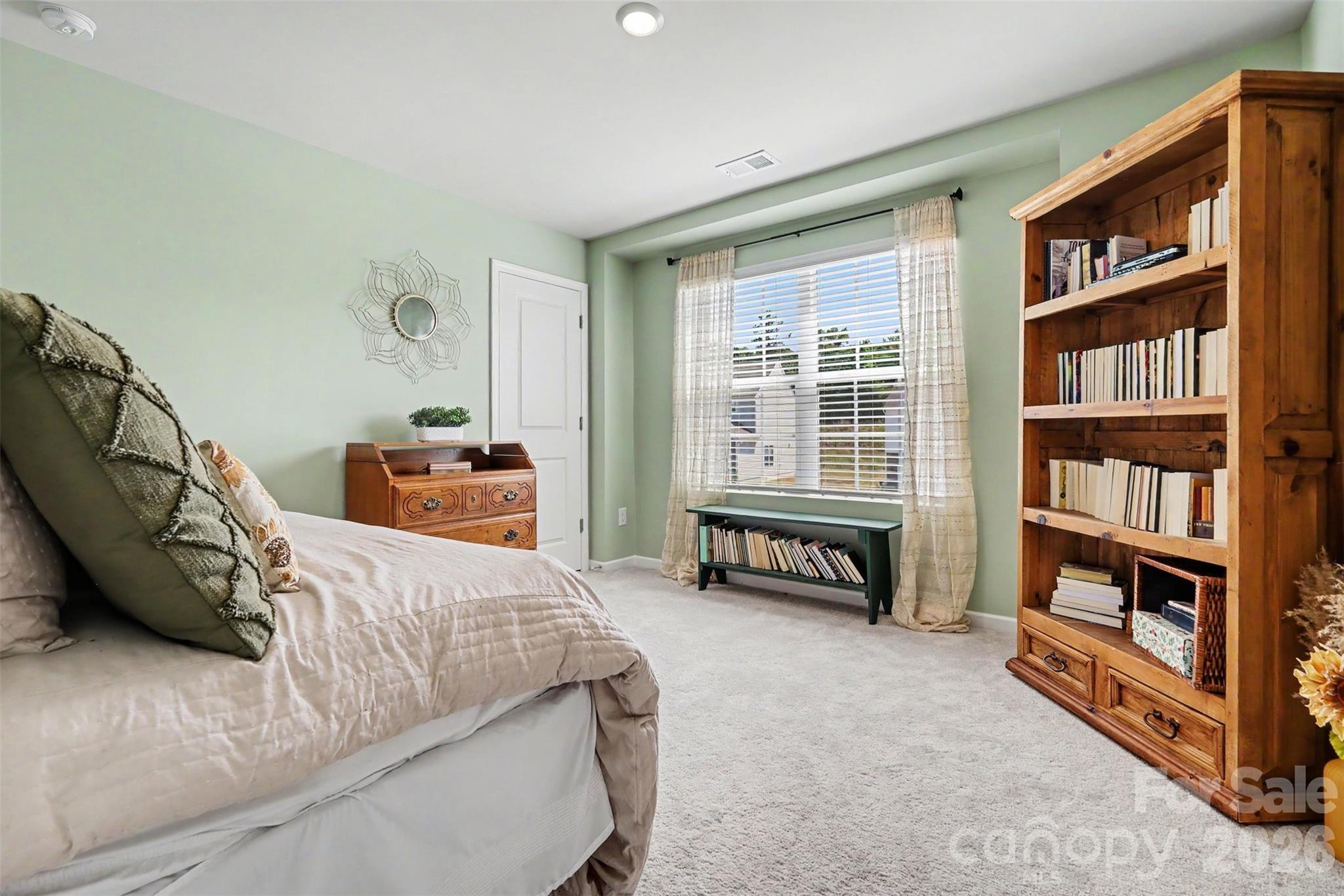 633 Mile Crk Road Edgemoor, SC 29712 - Photo 15 of 26 a bed room with a bed and a book shelf