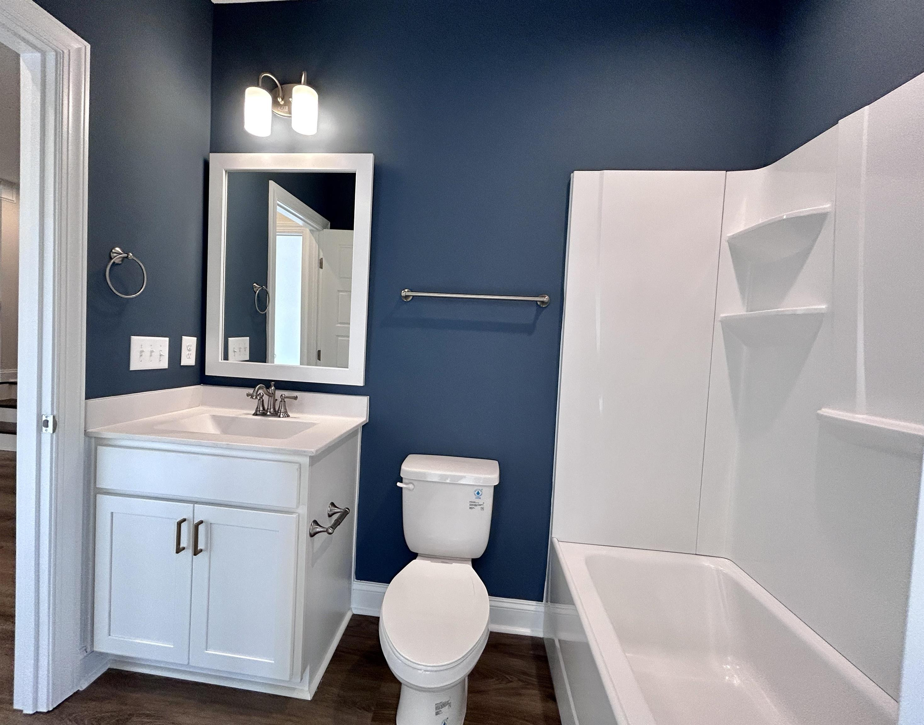 208 Kavanaugh Road Wake Forest, NC 27587 - Photo 11 of 23 a bathroom with a toilet sink and mirror