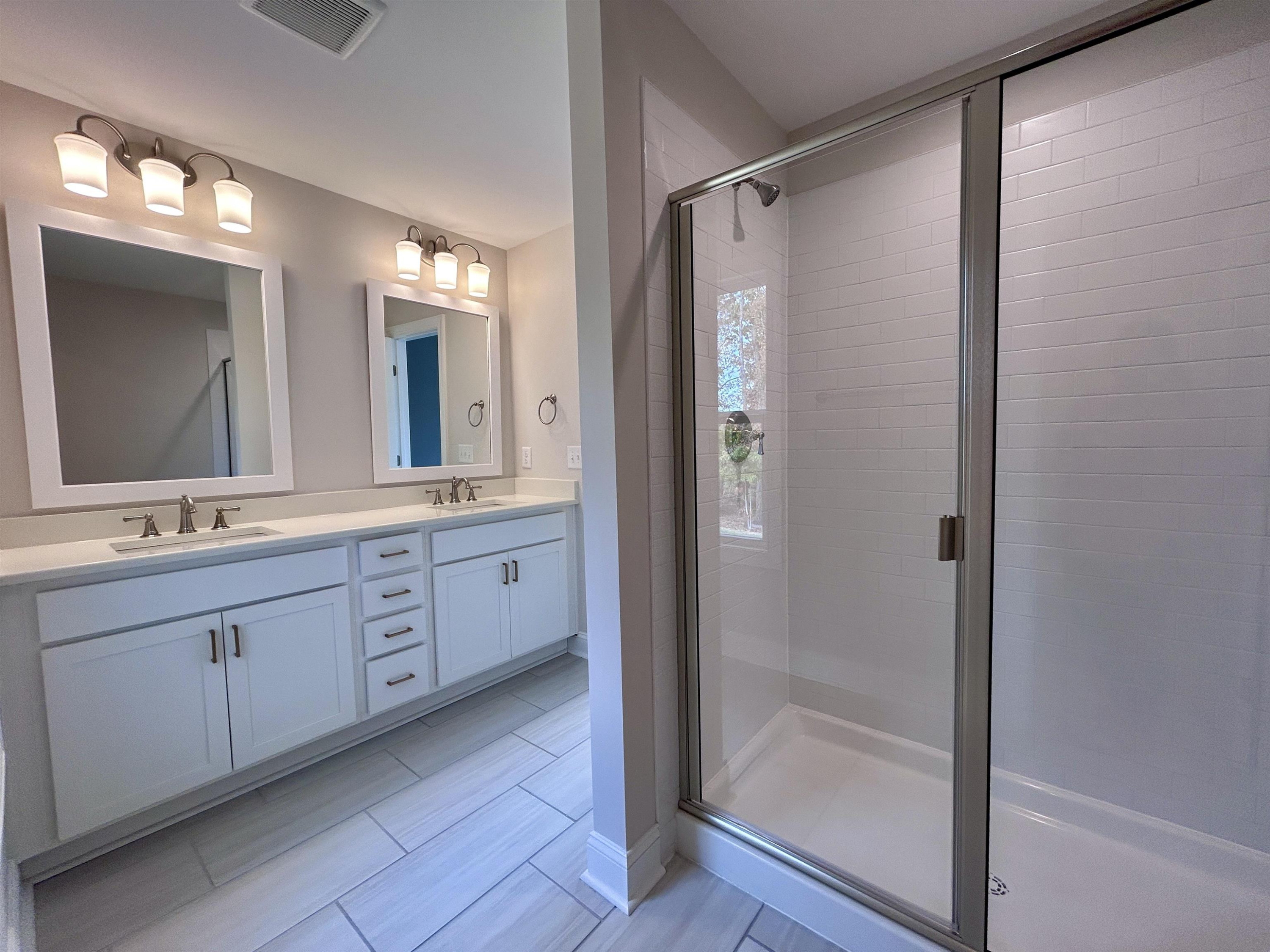 208 Kavanaugh Road Wake Forest, NC 27587 - Photo 14 of 23 a bathroom with a double vanity sink mirror and double