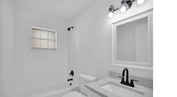 a view of a room with wooden floor and windows