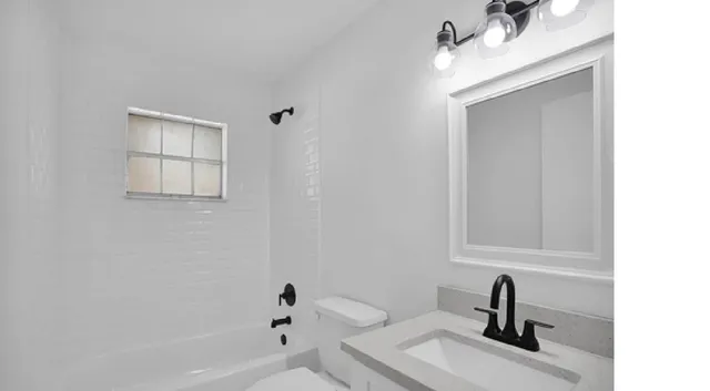 a view of a room with wooden floor and windows