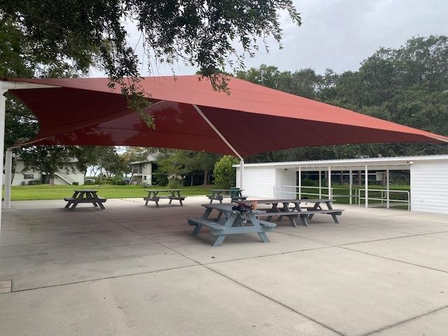 1010 San Remo Road St. Augustine, FL 32086 - Photo 26 of 47 a view of a patio with table and chairs under an umbrella