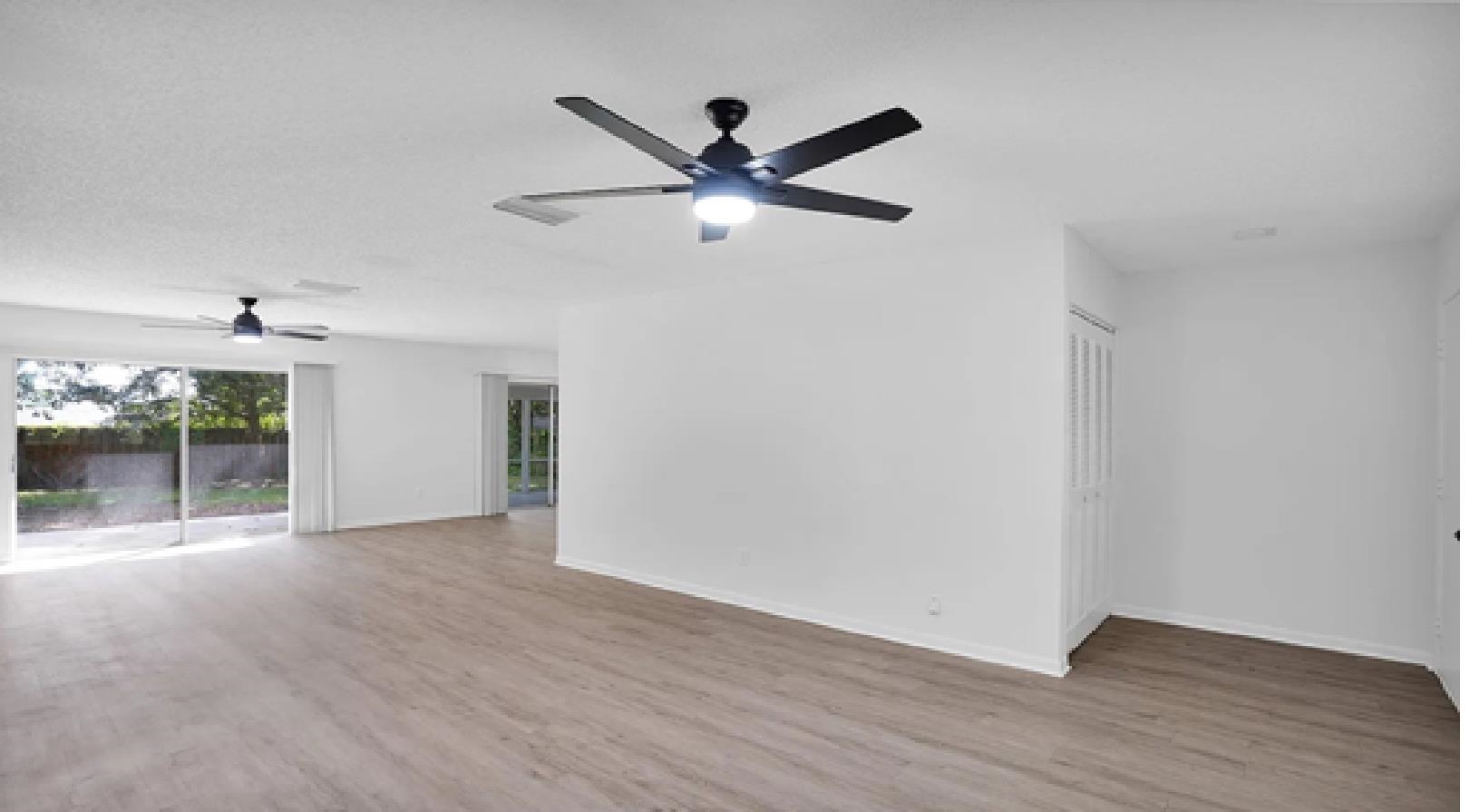 1010 San Remo Road St. Augustine, FL 32086 - Photo 3 of 47 a view of a livingroom with a ceiling fan wooden floor and a ceiling fan