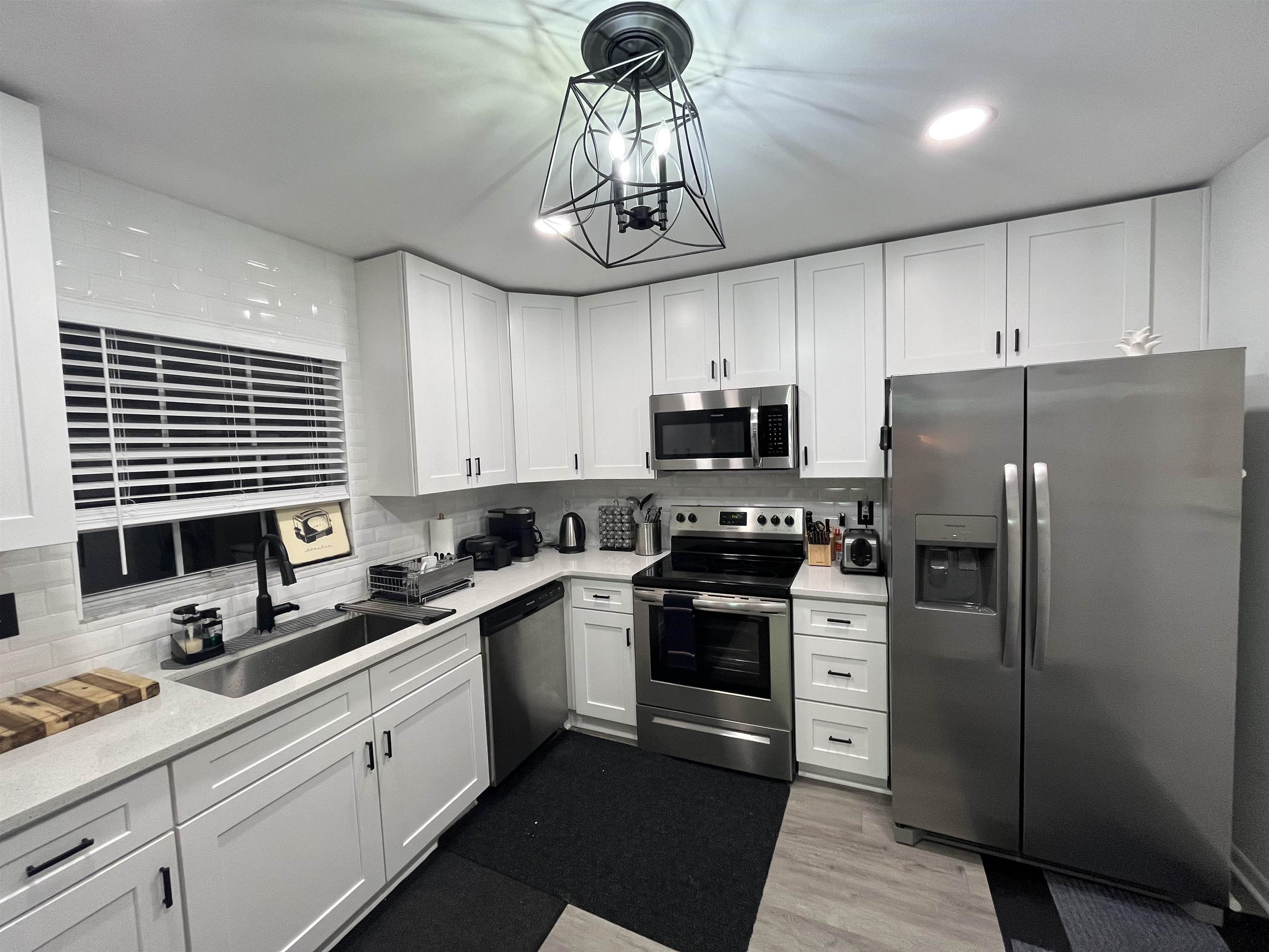 1010 San Remo Road St. Augustine, FL 32086 - Photo 34 of 47 a kitchen with stainless steel appliances a refrigerator a sink a stove a microwave and cabinets