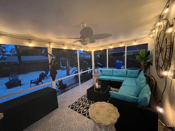 a backyard of a house with fountain table and chairs