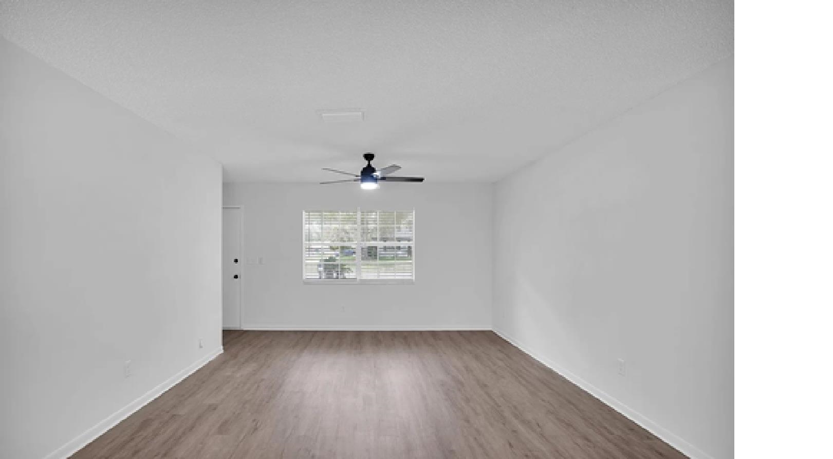 1010 San Remo Road St. Augustine, FL 32086 - Photo 5 of 47 a view of an empty room with wooden floor and a window