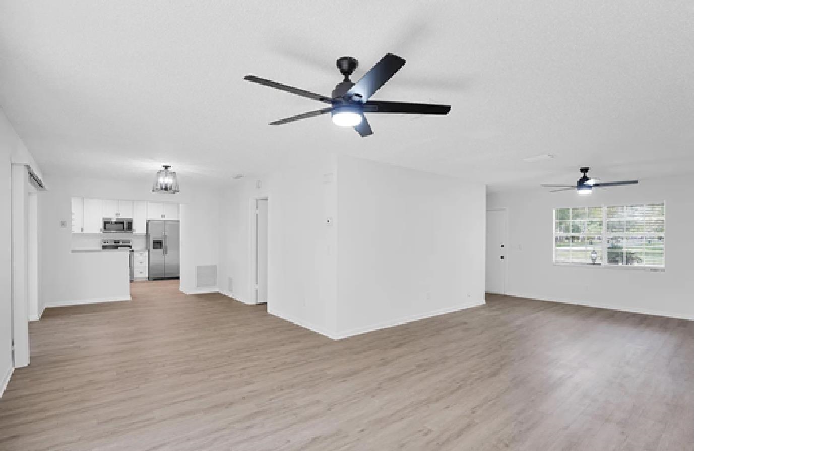 1010 San Remo Road St. Augustine, FL 32086 - Photo 6 of 47 a view of a livingroom with a ceiling fan and wooden floor