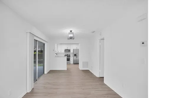 a view of a hallway with a chandelier