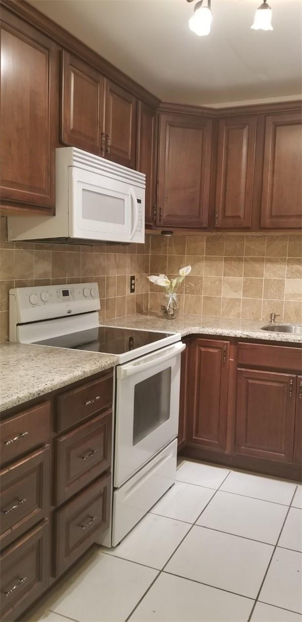 255 South Cypress Road, Unit 301 Pompano Beach, FL 33060 - Photo 1 of 42 a kitchen with a sink a stove and cabinets