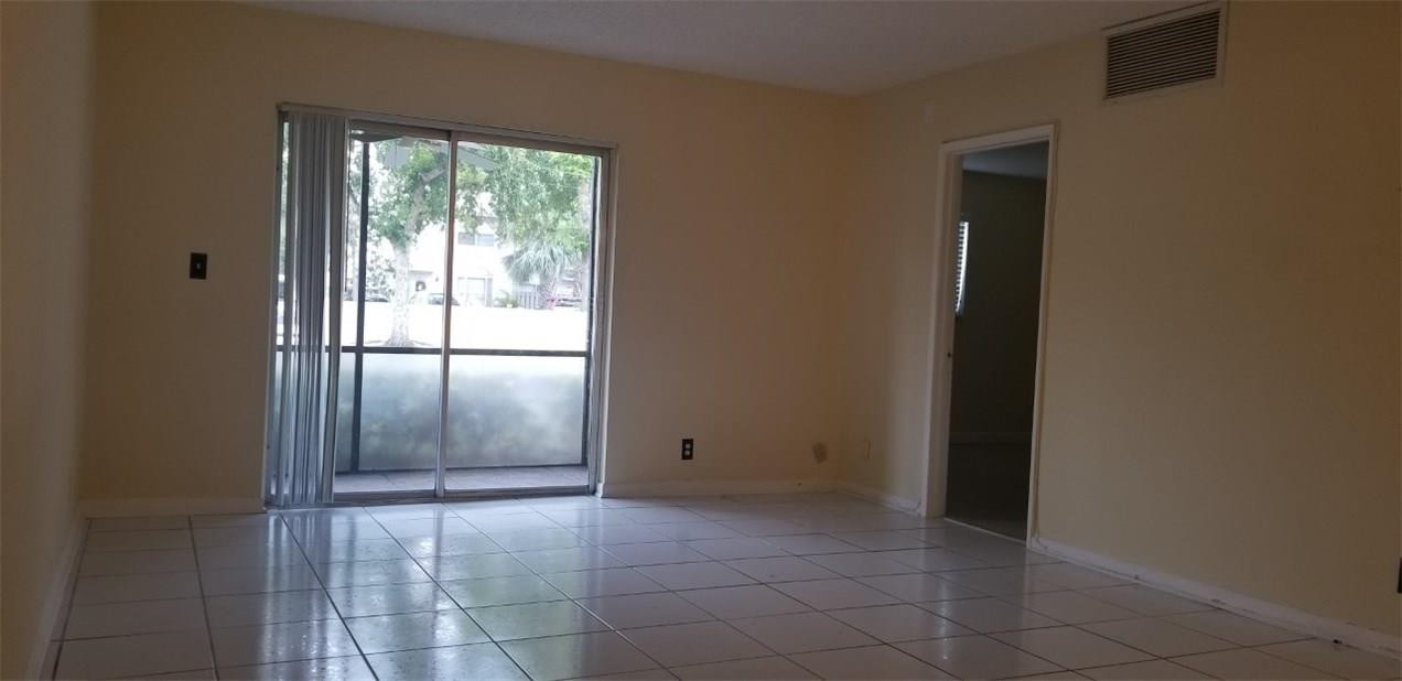 255 South Cypress Road, Unit 301 Pompano Beach, FL 33060 - Photo 11 of 42 a view of an empty room with a window