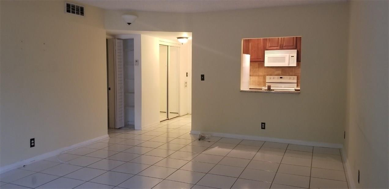 255 South Cypress Road, Unit 301 Pompano Beach, FL 33060 - Photo 13 of 42 an empty room with windows