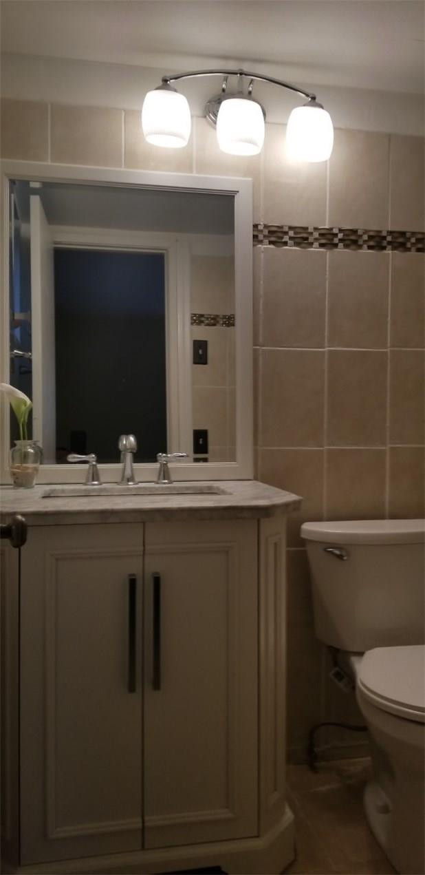 255 South Cypress Road, Unit 301 Pompano Beach, FL 33060 - Photo 19 of 42 a bathroom with a toilet sink and mirror