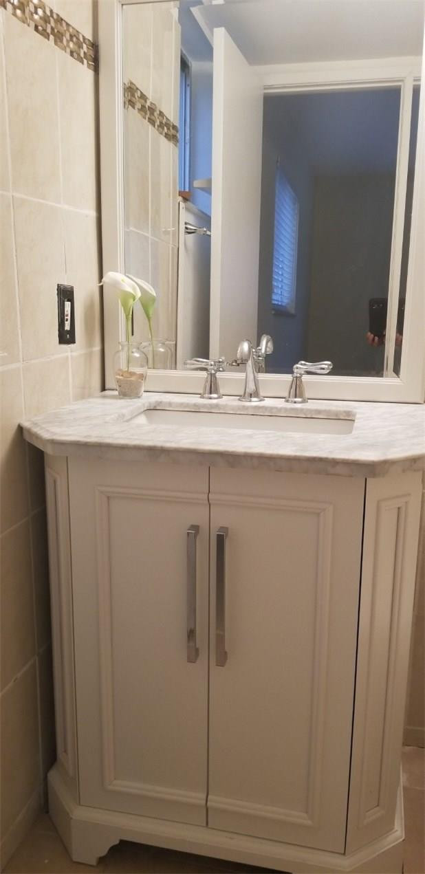 255 South Cypress Road, Unit 301 Pompano Beach, FL 33060 - Photo 20 of 42 a bathroom with a double vanity sink and a mirror