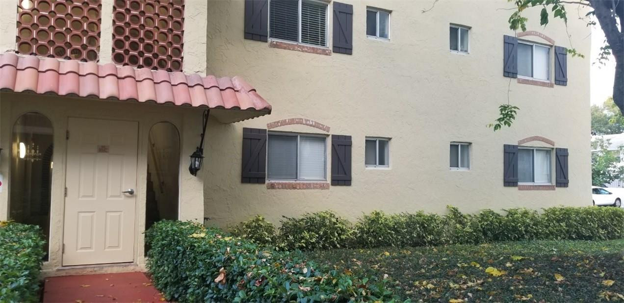 255 South Cypress Road, Unit 301 Pompano Beach, FL 33060 - Photo 36 of 42 a front view of a house with plants