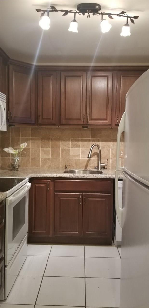 255 South Cypress Road, Unit 301 Pompano Beach, FL 33060 - Photo 4 of 42 a kitchen with stainless steel appliances granite countertop a sink and a stove