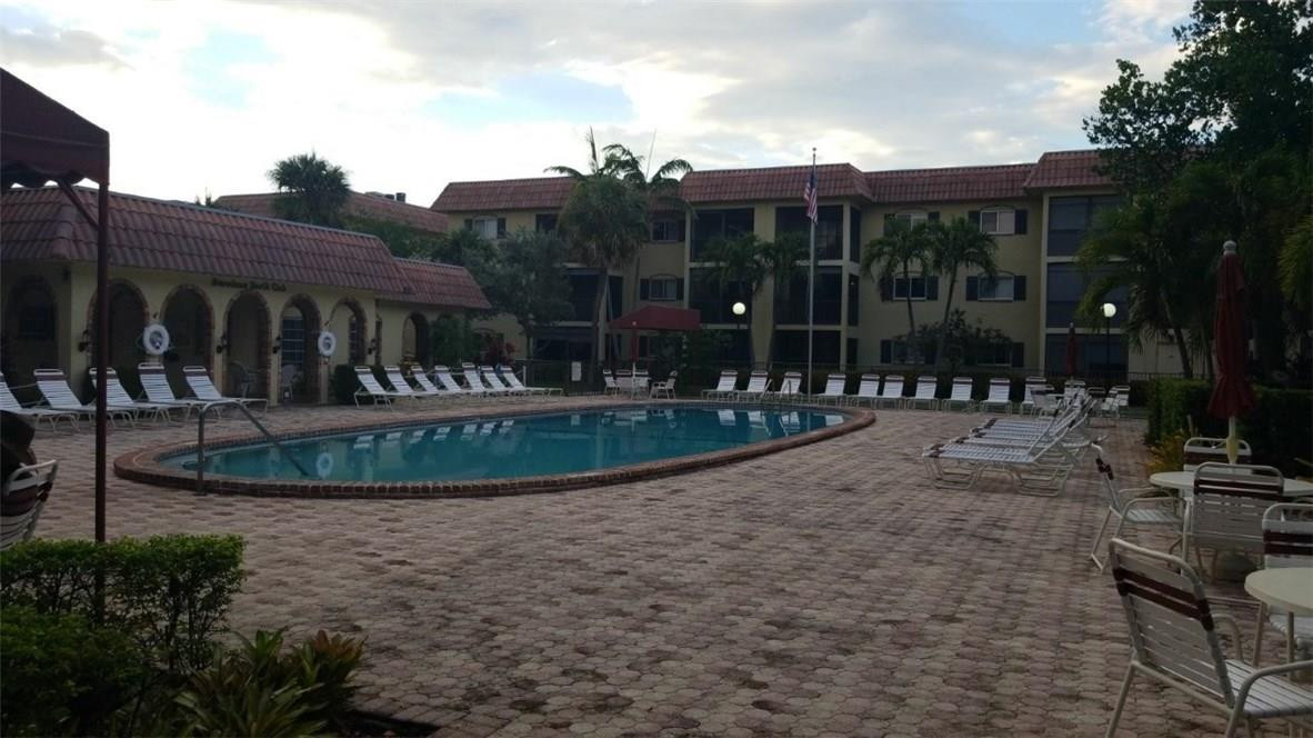 255 South Cypress Road, Unit 301 Pompano Beach, FL 33060 - Photo 41 of 42 a view of a house with backyard and porch