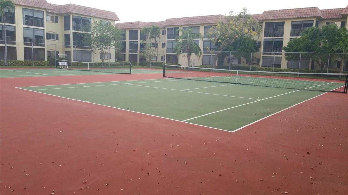 255 South Cypress Road, Unit 301 Pompano Beach, FL 33060 - Photo 42 of 42 a view of a tennis ground with a large trees