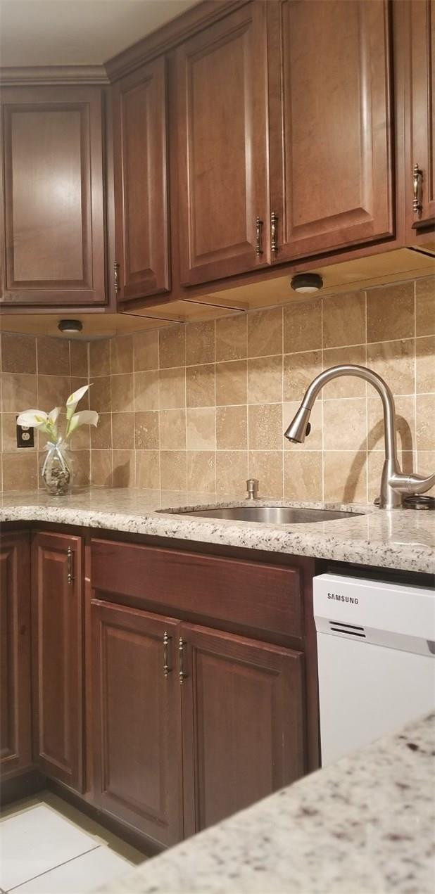 255 South Cypress Road, Unit 301 Pompano Beach, FL 33060 - Photo 6 of 42 a kitchen with granite countertop a sink a stove and cabinets
