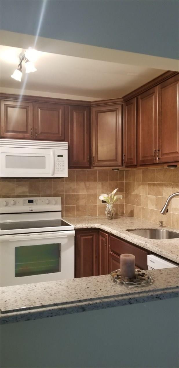 255 South Cypress Road, Unit 301 Pompano Beach, FL 33060 - Photo 8 of 42 a kitchen with granite countertop a sink and cabinets