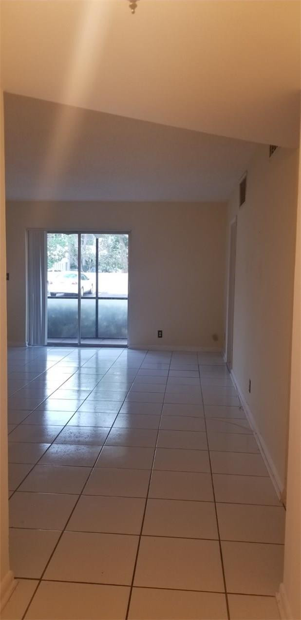 255 South Cypress Road, Unit 301 Pompano Beach, FL 33060 - Photo 10 of 42 a view of empty room with windows