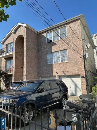a front view of a house with parking space