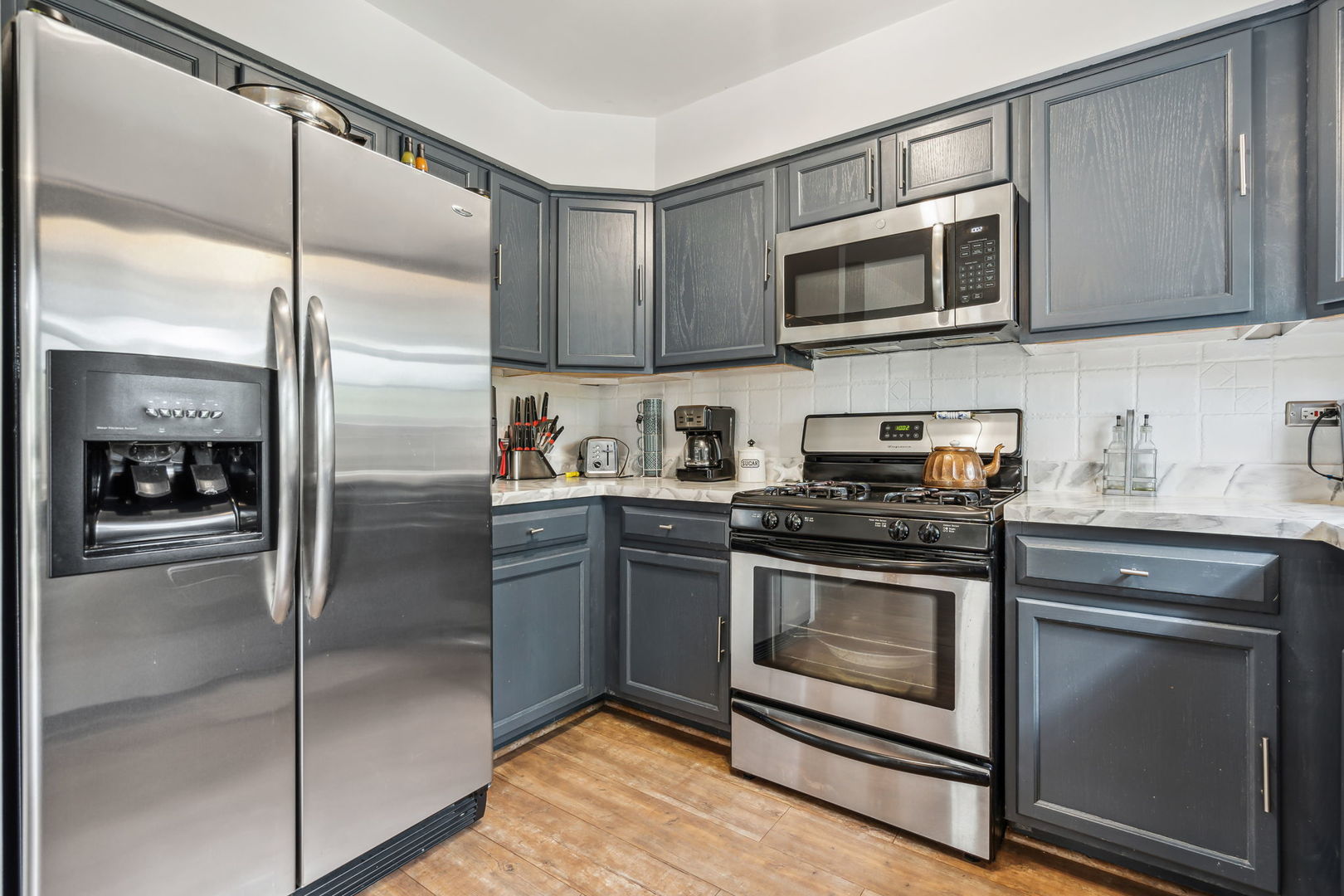 238 Ironbark Way Bolingbrook, IL 60440 - Photo 9 of 21 a kitchen with stainless steel appliances granite countertop a stove a refrigerator and a microwave