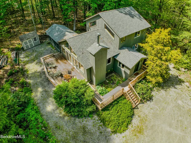 an aerial view of a house with yard