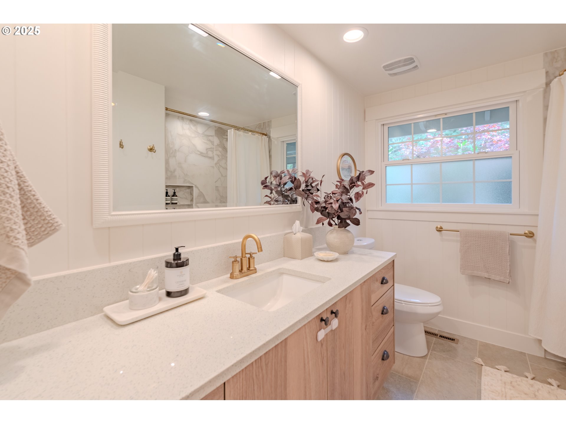 20908 Northeast 67th Avenue Battle Ground, WA 98604 - Photo 17 of 47 a bathroom with a sink a toilet and a mirror